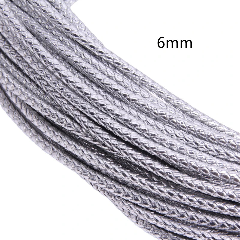 Close-up of a silver braided leather cord, 6mm in diameter, shown in a spool or length.