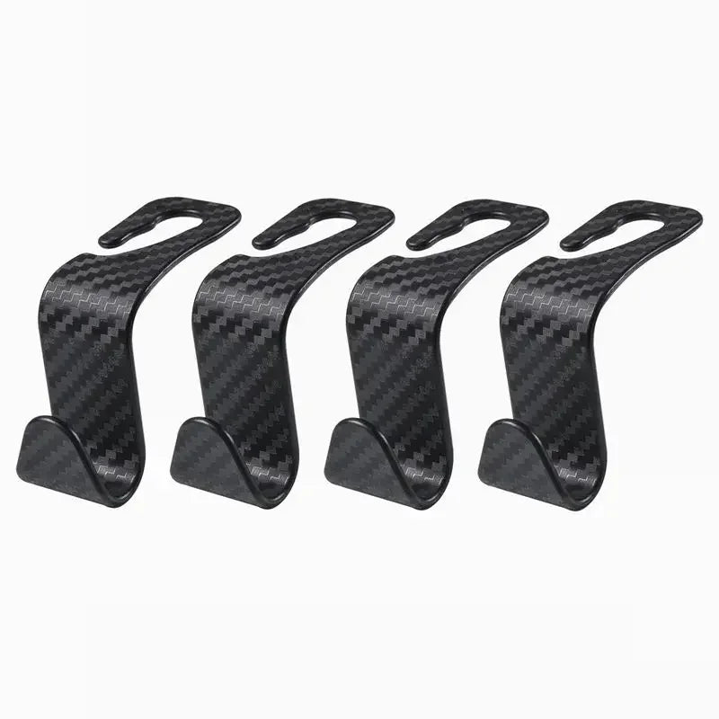 A pair of black carbon fiber car headrest hooks used for storing bags, clothes, and other items.