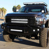 A black truck equipped with 18W LED flood light pods on the grille and bumper.