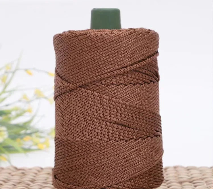 A spool of brown crochet ice rope with a green core, used for DIY crafts.