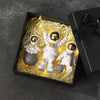 Handcrafted astronaut figurine resin spaceman desk decor displayed in a black box with gold lighting.