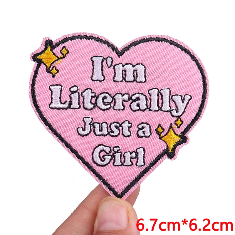 Pink heart shaped embroidered patch with text I'm Literally Just a Girl and gold stars