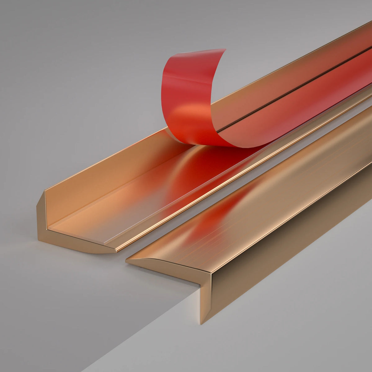 A close-up view of self-adhesive metal L-shaped corner protector strips in copper and red finishes.
