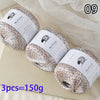 Three balls of glitter yarn are displayed on a light surface with a number 09 in the corner.