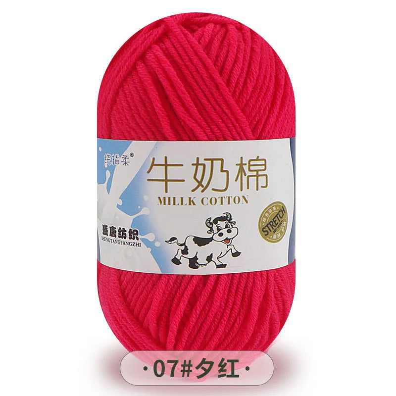 A skein of bright pink milk cotton blend yarn labeled in Chinese and English.