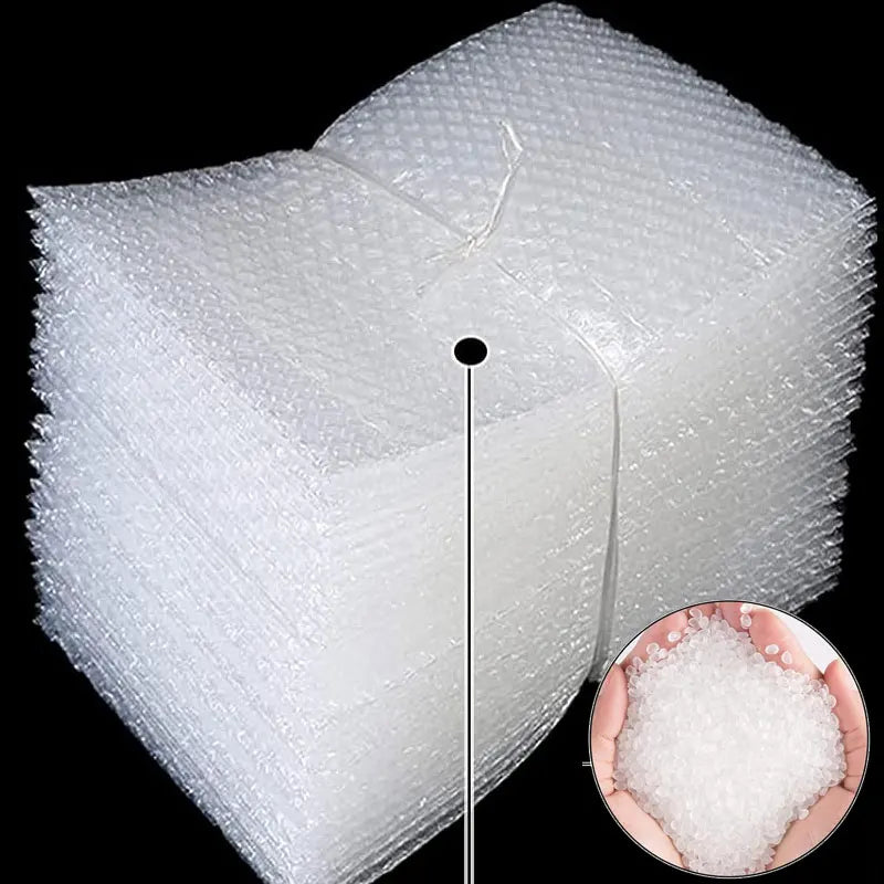 A stack of clear bubble mailers showing cushioned protection, with a small piece of white bubble wrap visible.