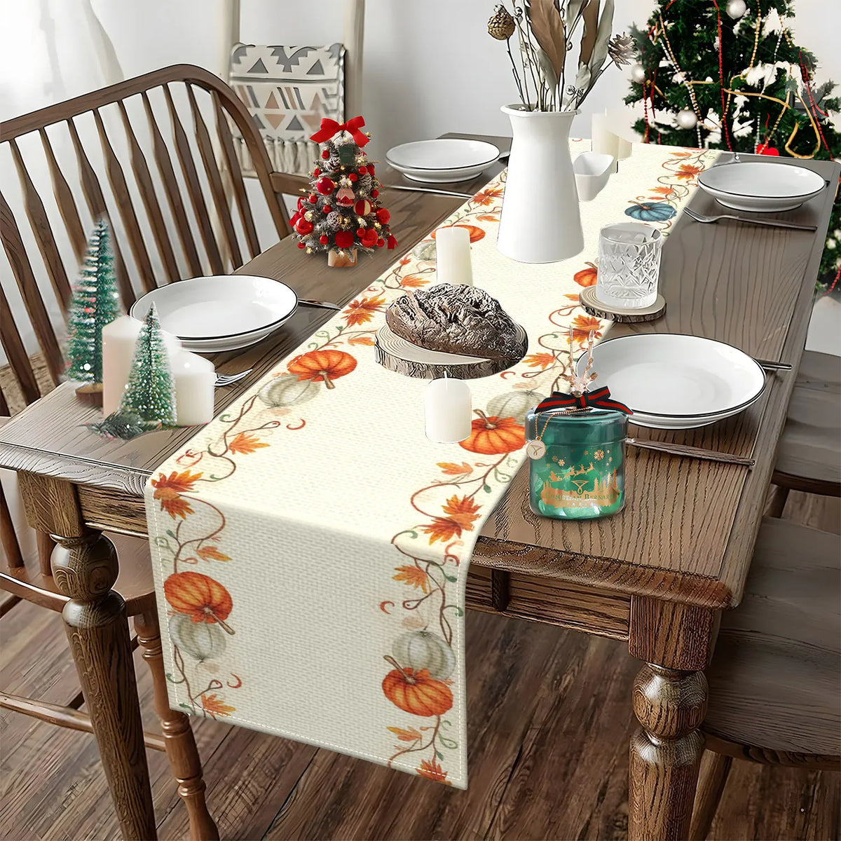 A table setting featuring a fall harvest table runner with orange pumpkins and autumn leaves on a wooden table.
