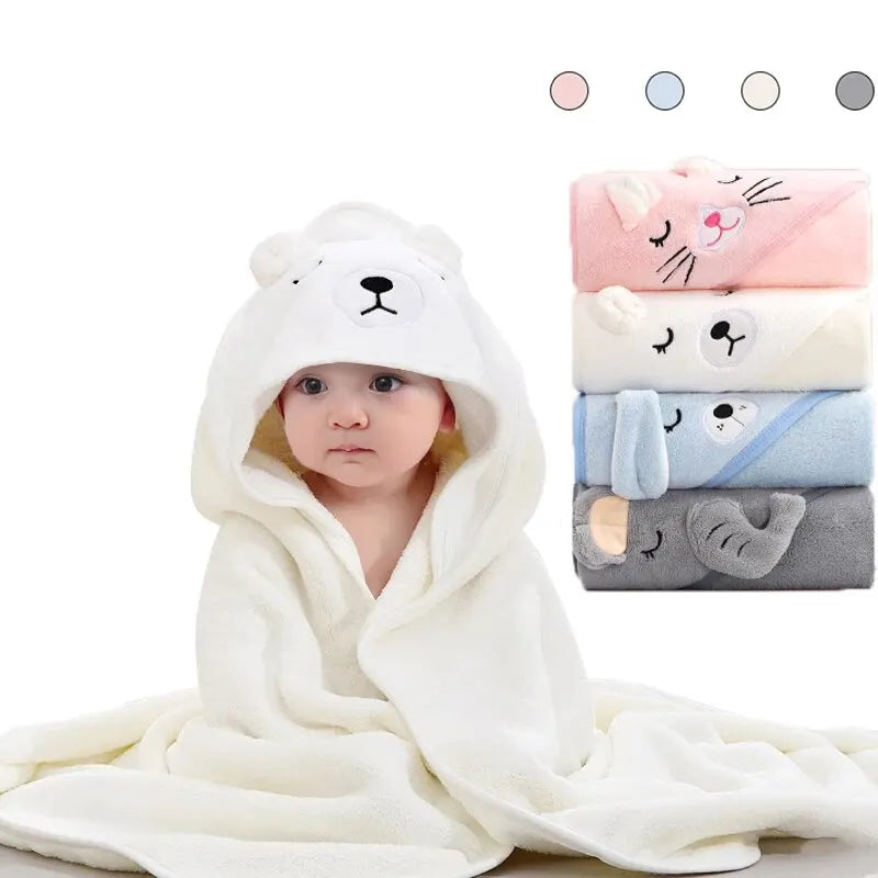 A white hooded baby bathrobe towel with a cat design is displayed next to various colored towels.