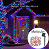 Multicolor solar-powered fairy string lights decorating a house with a porch and window.