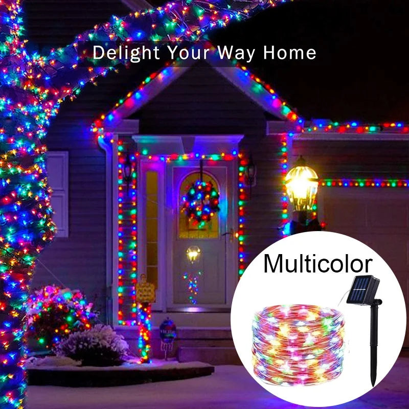Multicolor solar-powered fairy string lights decorating a house with a porch and window.