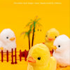 A close-up of several yellow and white simulation duck shape toys, realistic and cute appearance, set against a bright orange