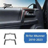 Carbon fiber trim kit for Toyota 4Runner featuring a black accent piece on the interior door panel.