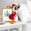 A knitted sweater and hat costume set for a desk goose statue decor featuring red and orange colors.