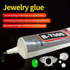 A bottle of B-7000 multi-purpose adhesive glue for jewelry and crafts, with a fine tip and small pieces of silver jewelry.