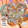 A hand holds a collection of hexagonal sticker book pages featuring various interior design scenes and DIY elements.