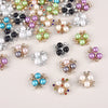 A collection of pearlized resin flower beads in various colors including pink, green, purple, and white.
