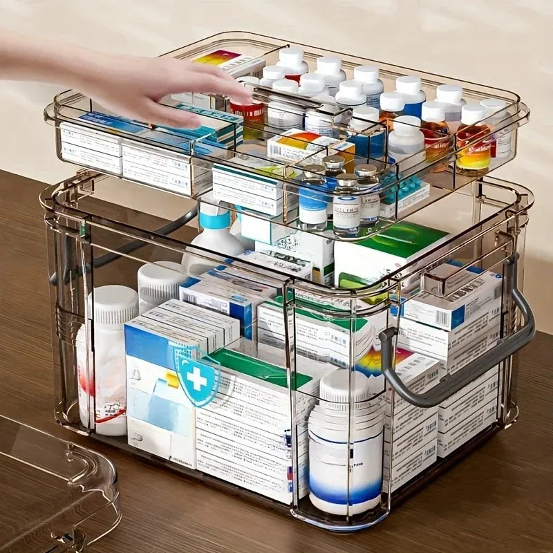 A clear plastic first aid storage box with a handle is shown, filled with various medical and first aid supplies.