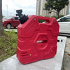 A red universal water tap faucet adapter is shown on a concrete surface next to a fuel can.