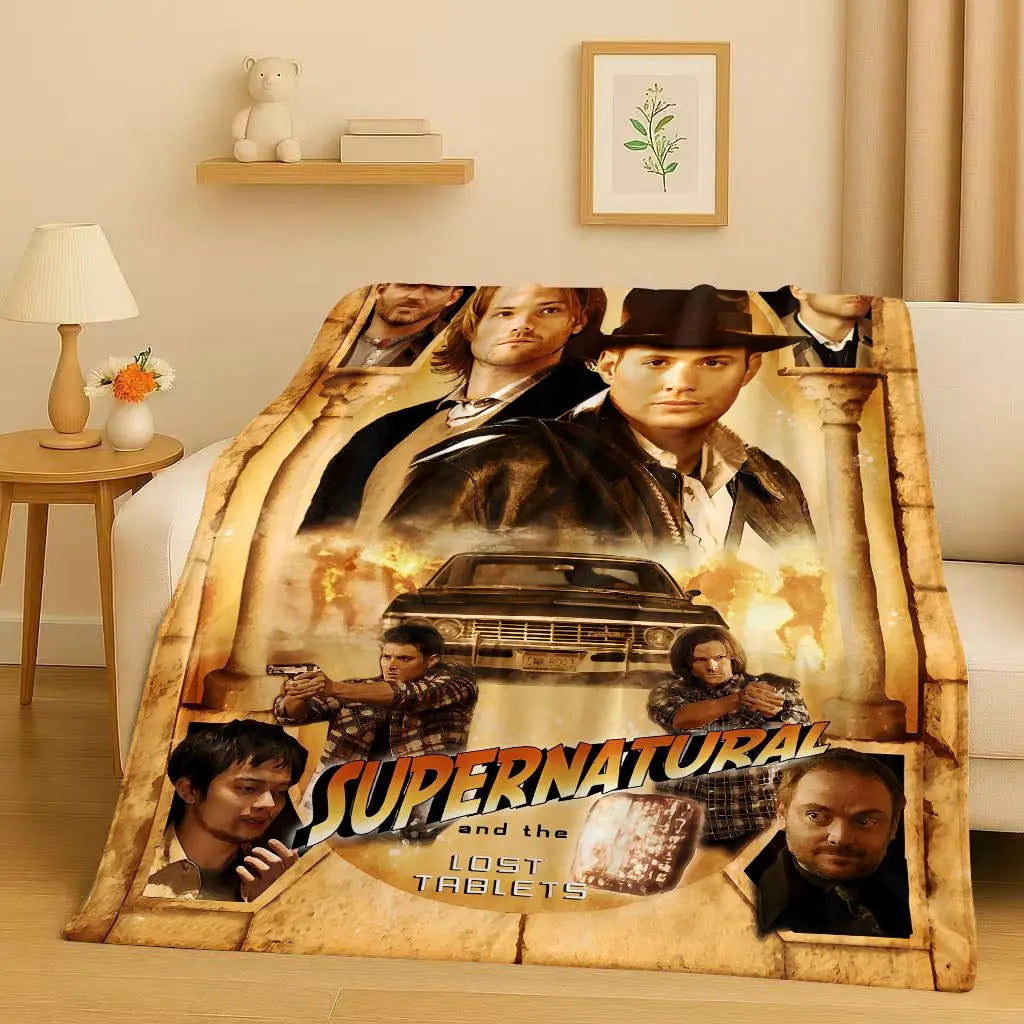 A large print featuring characters from the Supernatural TV show and the title Lost Tablets on a fabric blanket.