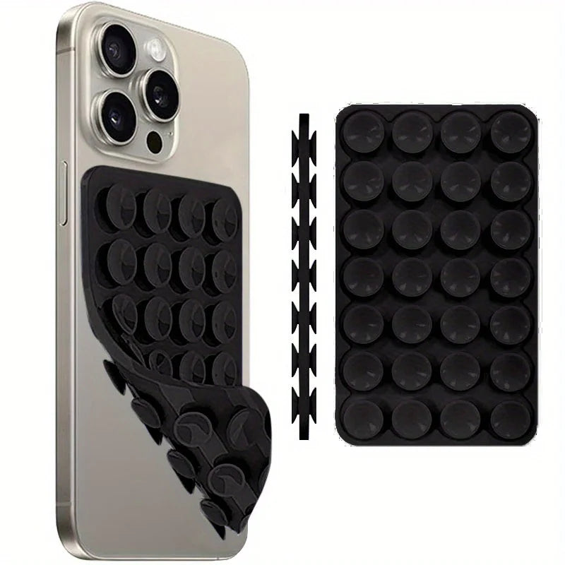 A silver smartphone case with a black silicone suction cup mount and an accompanying black mounting strip.