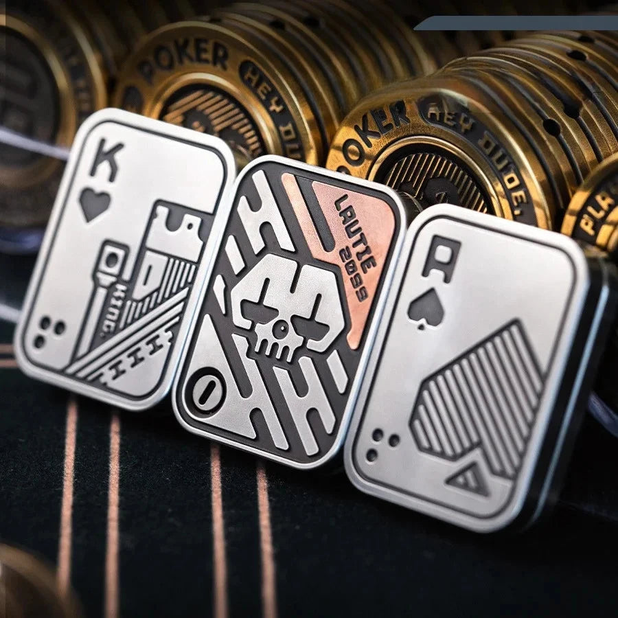 A close-up of metal poker cards with King, Ace, and other face cards resting on a dark surface.