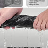 A hand is using a black microfiber cloth to wipe a surface, showing water dripping off the cloth.