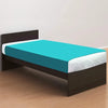 A dark brown bed frame with a teal fitted sheet and white bedding on a wooden floor.
