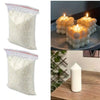 Two bags of white natural soy wax granules for DIY candle and skincare making next to lit candles.