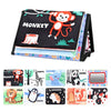 A black crinkle cloth book featuring various animal characters like a monkey, tiger, elephant, and panda, with a tummy time m