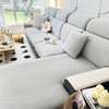 A light gray elegant jacquard sofa slipcover with an elastic fit shown in a bright, modern living room.