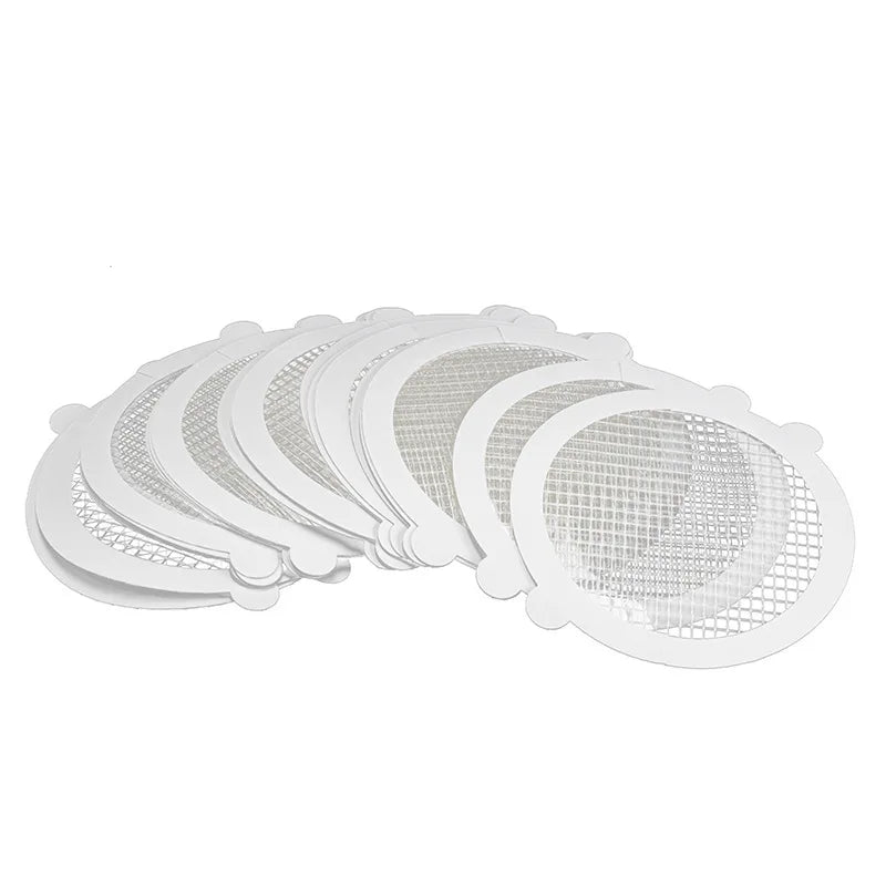 A collection of white mesh filters used as disposable shower drain hair catchers for sinks and floor drains.