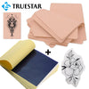 A kit containing skin and thermal transfer paper, including a decorative tattoo design and various sheets of paper.