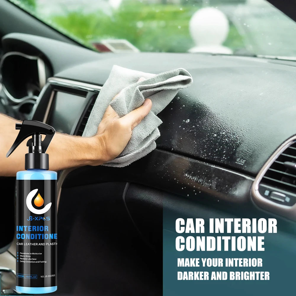 A hand is applying a car interior conditioner to the dashboard of a vehicle.