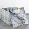 A stack of rectangular marble effect wall stickers featuring gray and black marble with gold veining.