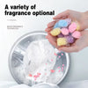 A hand holds a variety of colorful magic fragrance technology beads for laundry