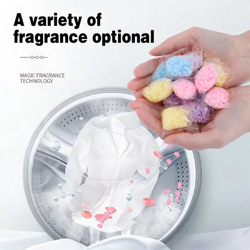 A hand holds a variety of colorful magic fragrance technology beads for laundry
