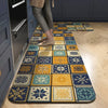 A long rectangular floor mat with a geometric pattern of blue, yellow, and teal squares placed on a light wood floor.