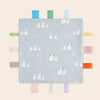A light blue baby sensory tag comfort blanket featuring white sheep illustrations and colorful fabric tags.