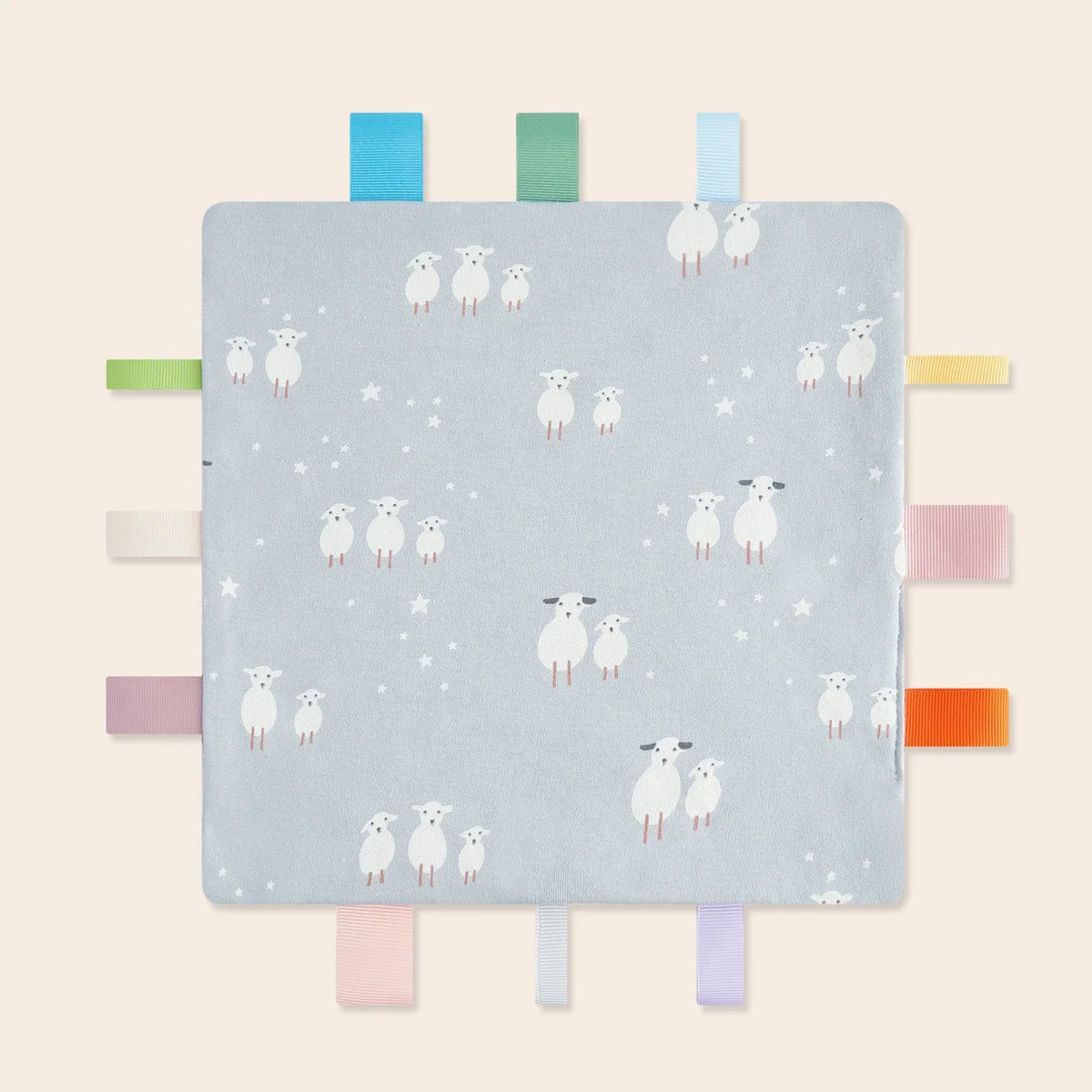 A light blue baby sensory tag comfort blanket featuring white sheep illustrations and colorful fabric tags.