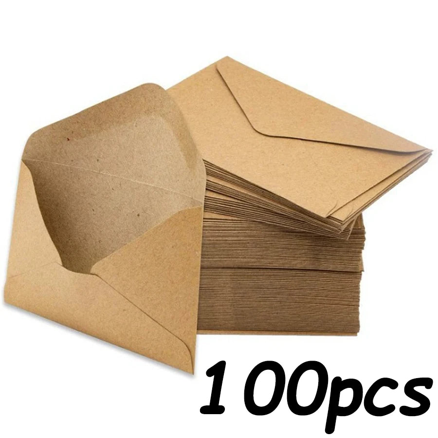 A stack of brown kraft paper envelopes for invitations, letters, and mailing.