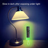 A glow-in-the-dark silicone remote cover is illuminated by a lamp, showing its light emission.