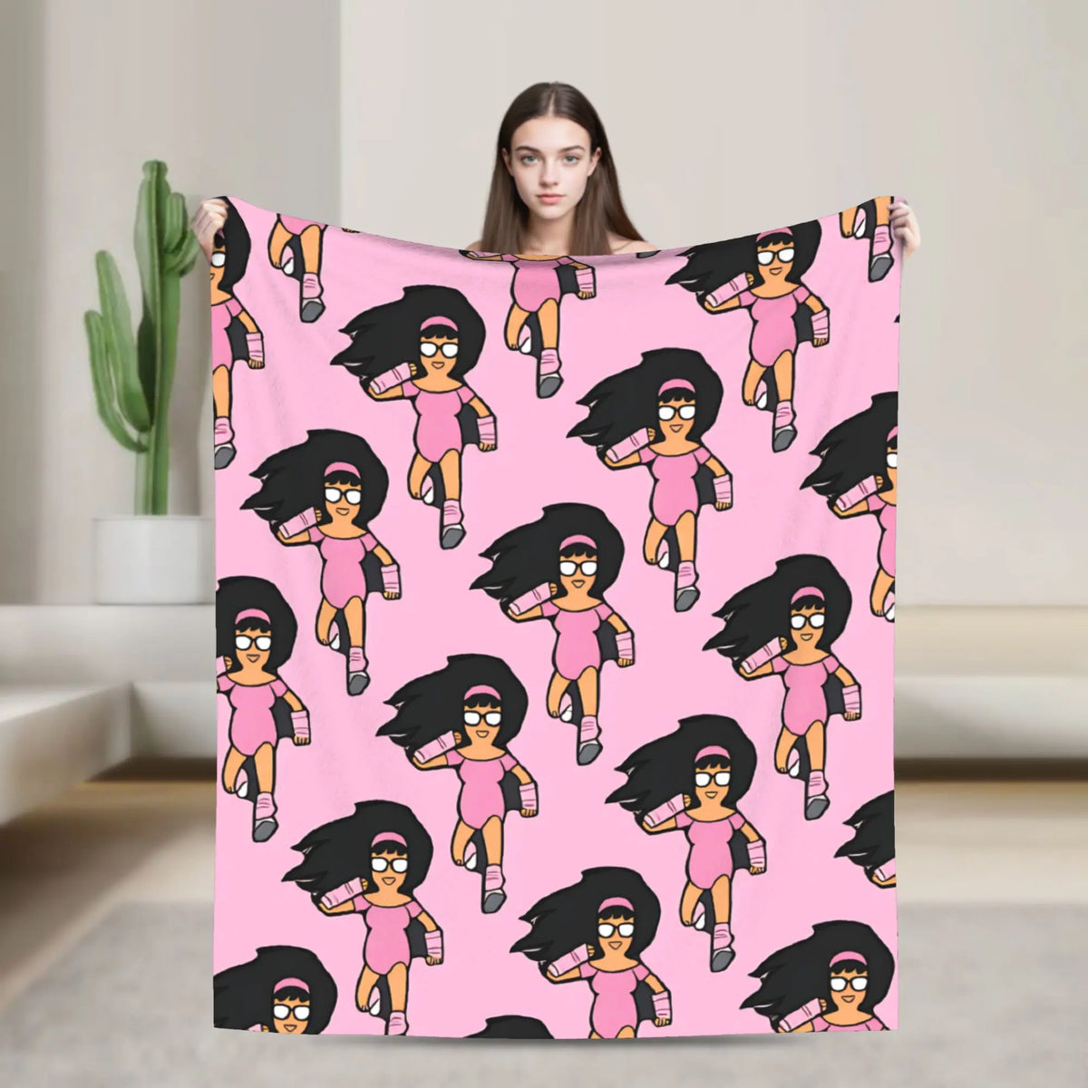 A pink cartoon character blanket featuring a stylized female figure with black hair and glasses in a running pose.