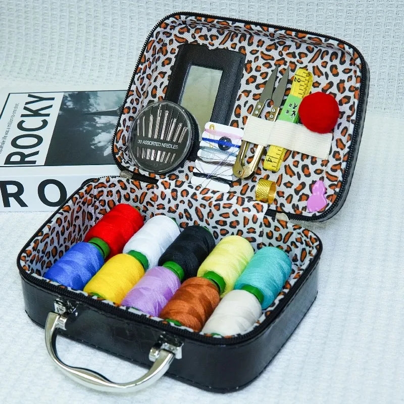 Portable faux leather sewing kit organizer with a black case featuring needles, scissors, and spools of colored thread.