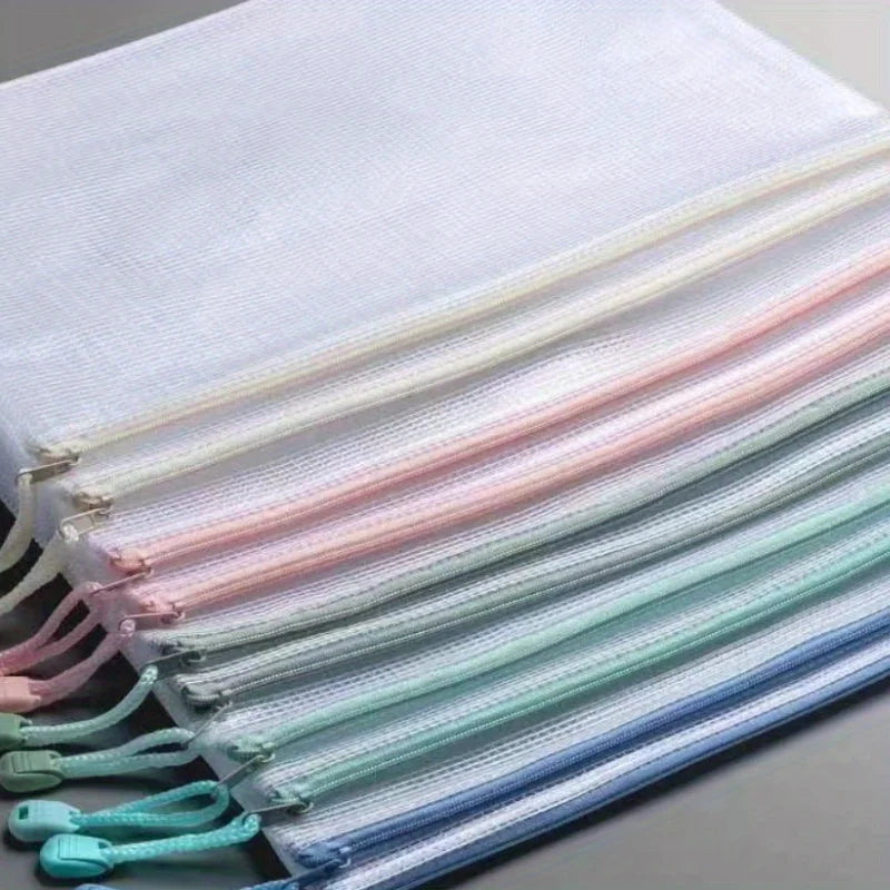 A set of ten white, pink, and light blue mesh zipper bags for classroom and craft organization.