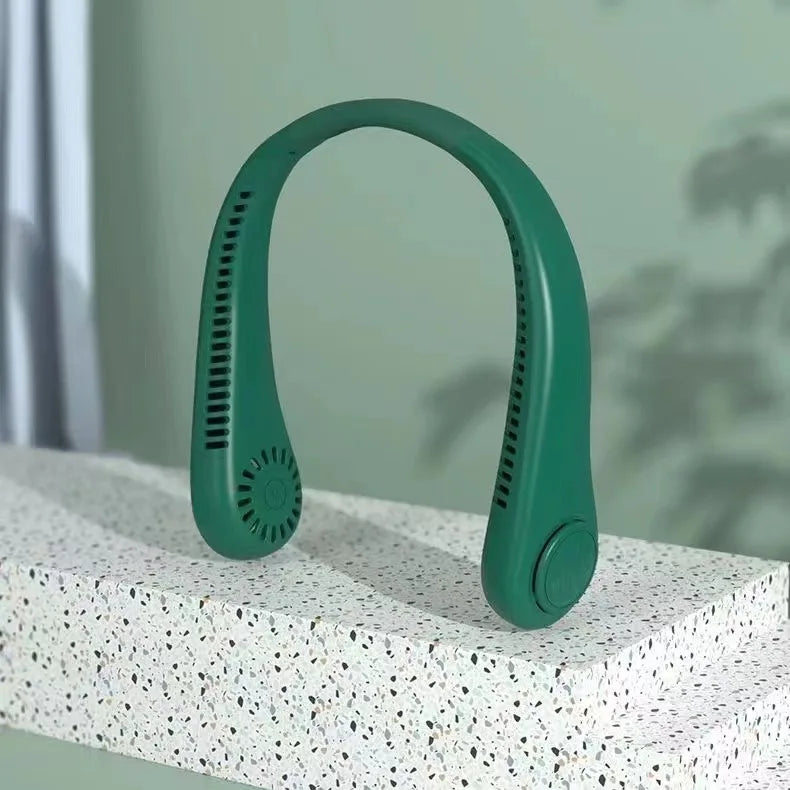 A green hands-free bladeless neck fan with a digital display resting on a white textured surface.