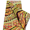 A close-up view of pink glitter African wax print fabric in a vibrant pattern.