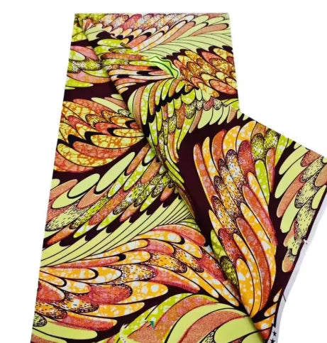 A close-up view of pink glitter African wax print fabric in a vibrant pattern.