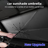 A hand is deploying a black foldable car sunshade umbrella inside a car's interior dashboard.