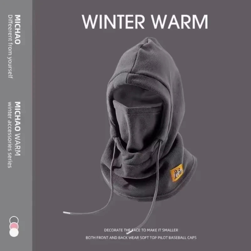 A dark gray winter balaclava with a hood and mask is displayed against a solid gray background.