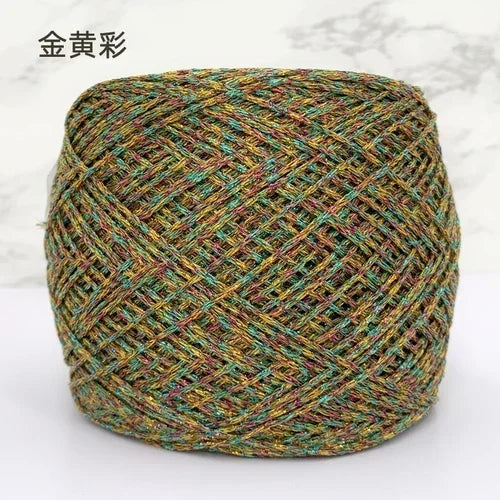 A ball of metallic silk crochet yarn with a gold and silver shimmer thread for knitting and macrame.